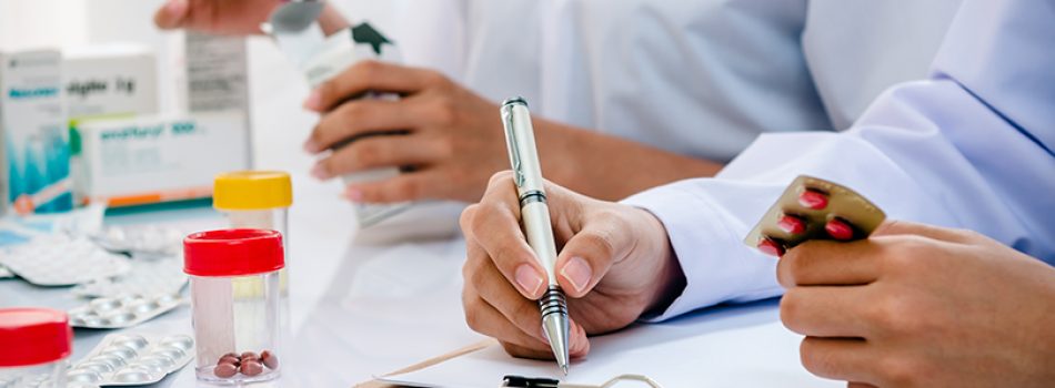 two pharmacists preparing prescription and medicine box